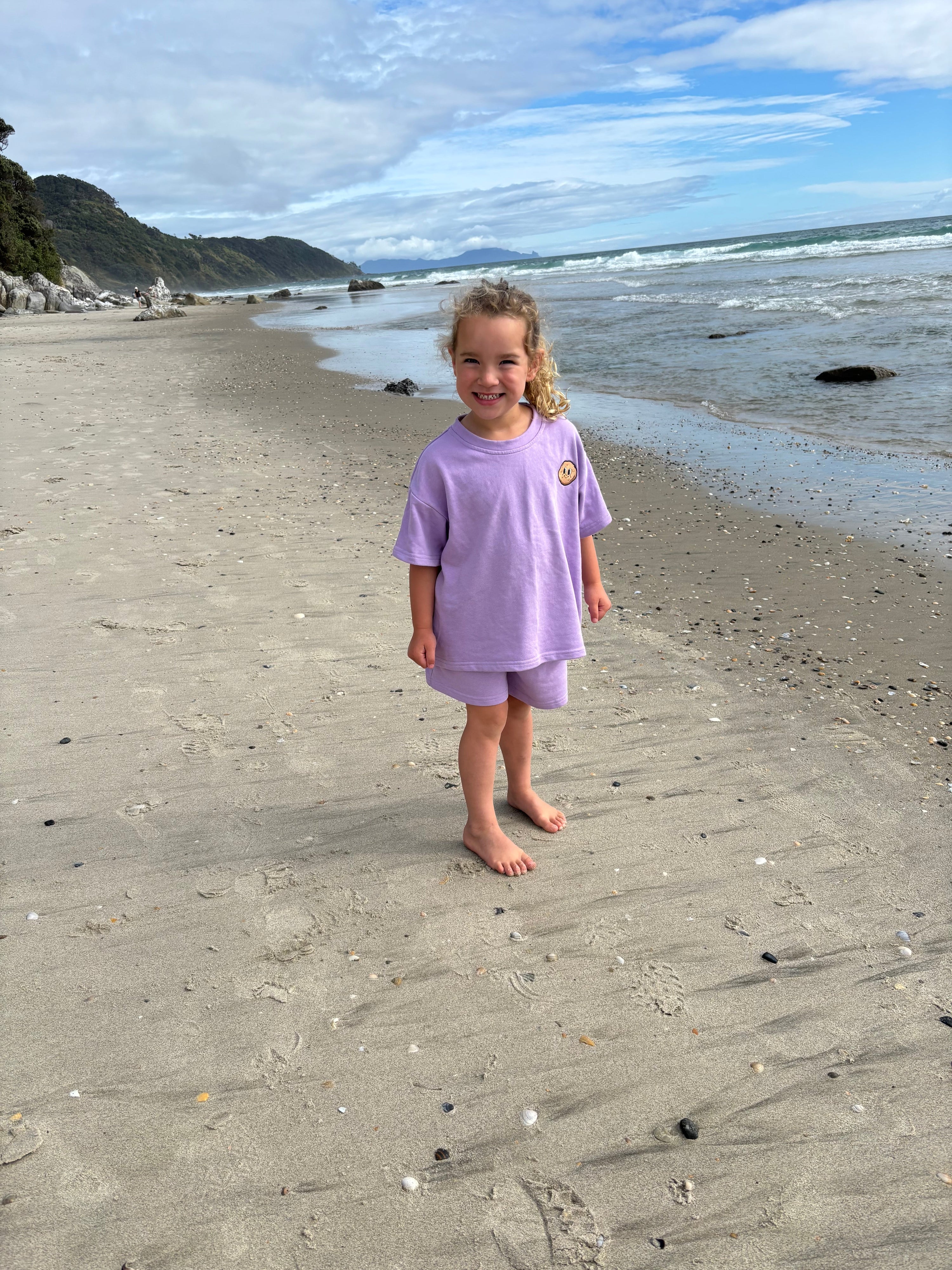 Happy kid wearing Crumb by the beach