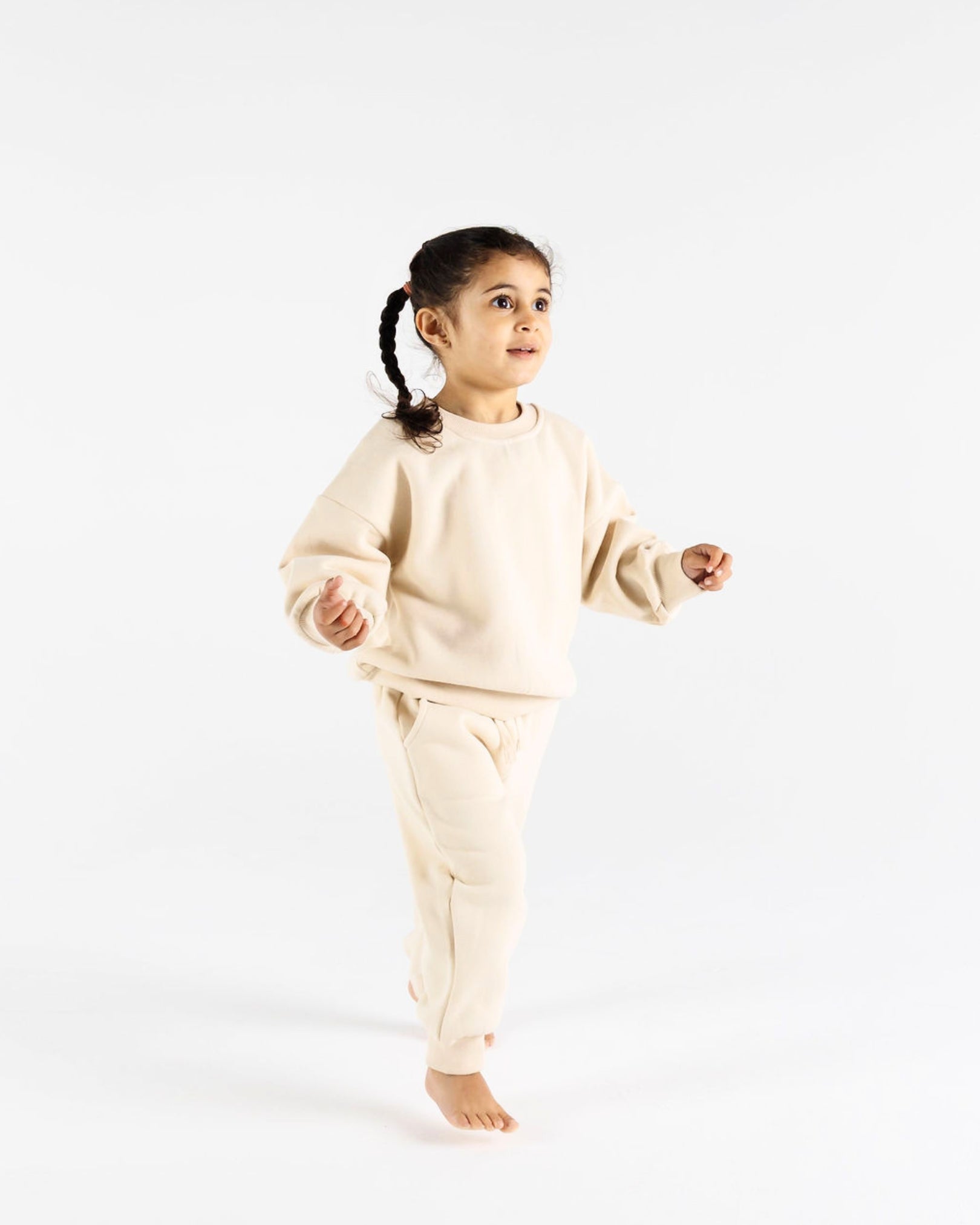 A Cool young girl with dark hair  wearing Crumb's Downtown Set Pistachio Truffle