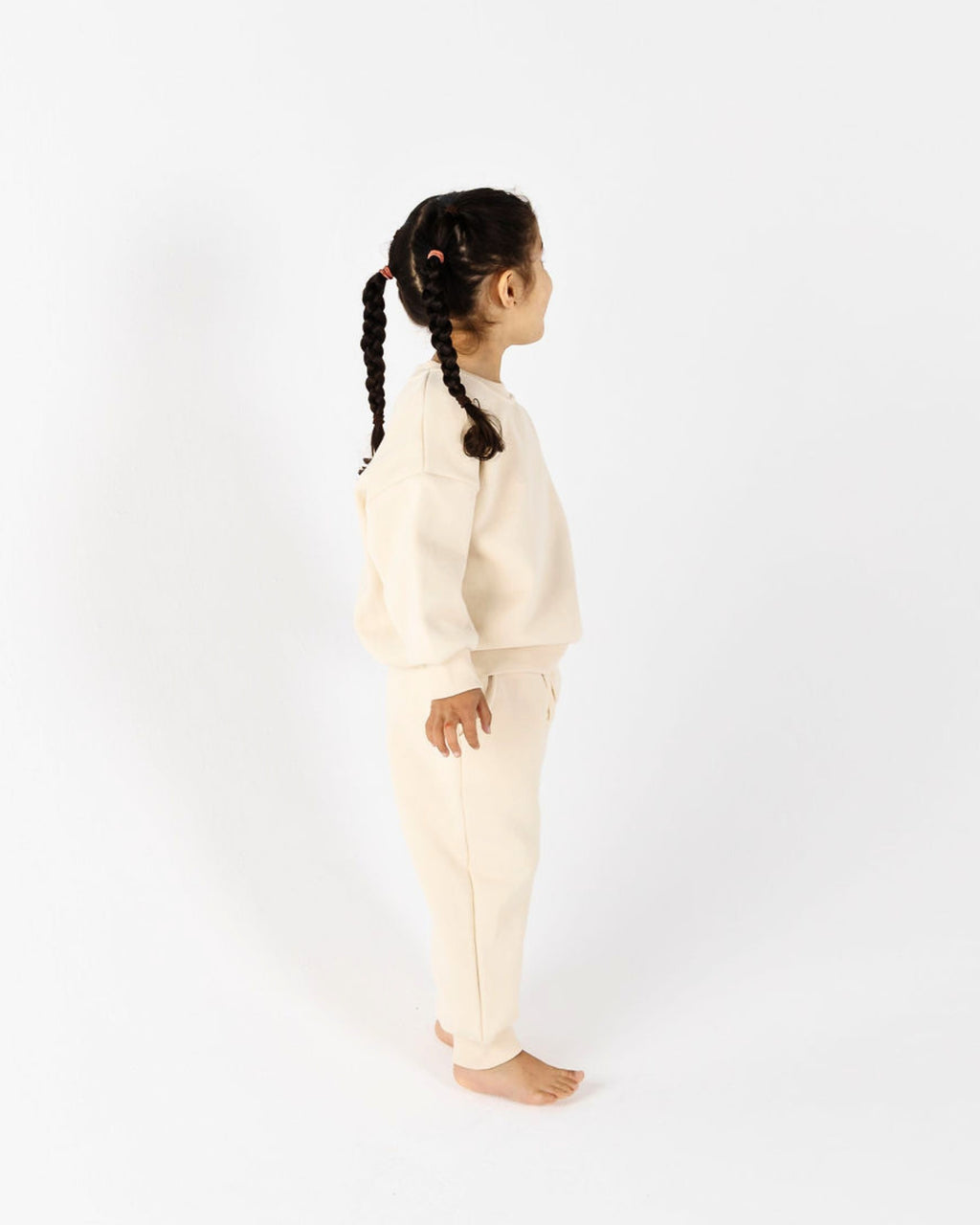 Girl playing outdoors in Crumb's Downtown Set - Milk White kids tracksuit