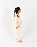 Girl playing outdoors in Crumb's Downtown Set - Milk White kids tracksuit