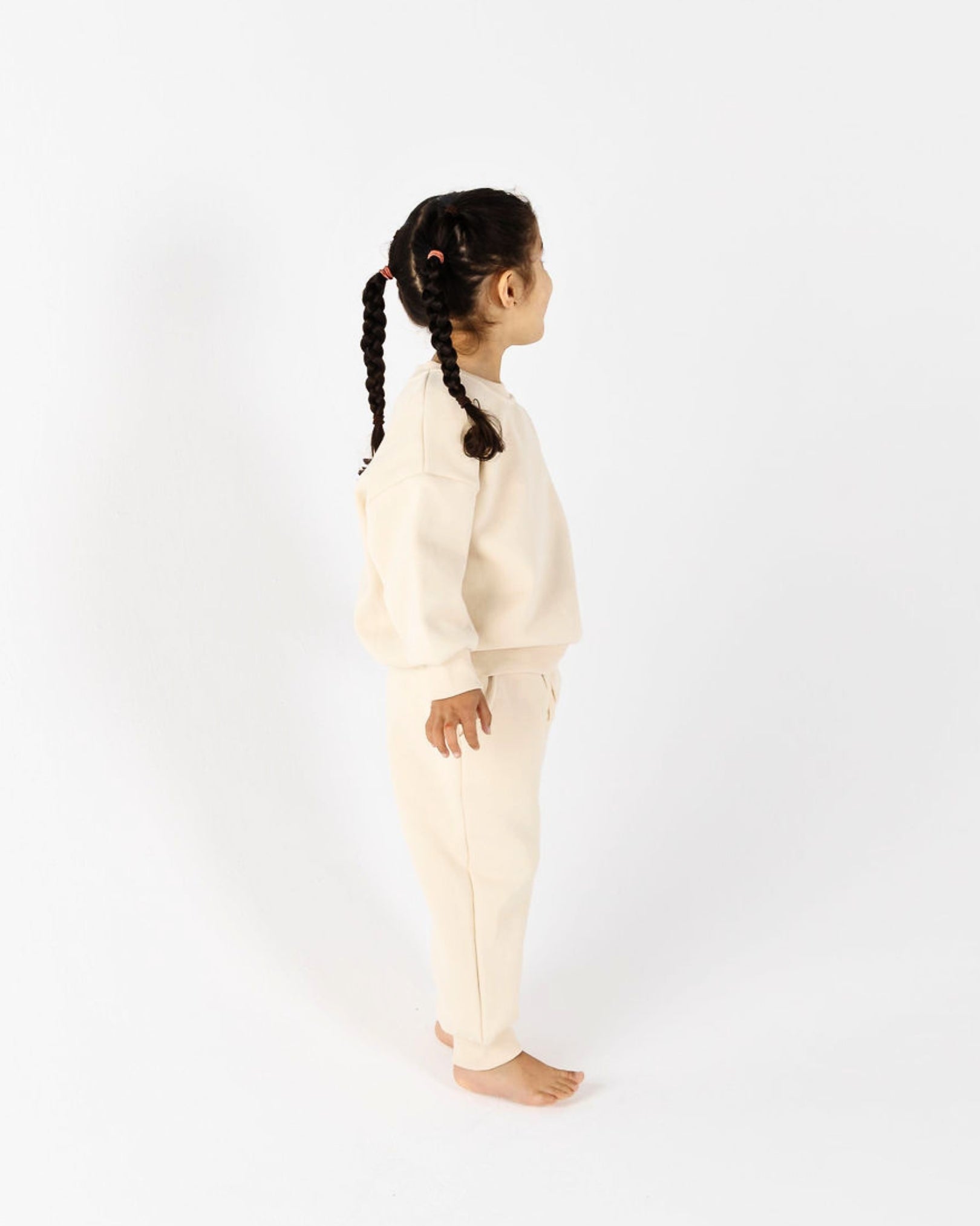 A Cool young girl with dark hair  wearing Crumb's Downtown Set Pistachio Truffle
