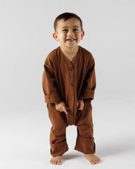 Child wearing a brown crumb.co.nz jumpsuit outfit in chocolate brown. 
