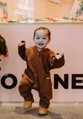 Child in Chocolate Brown Overalls from Crumb