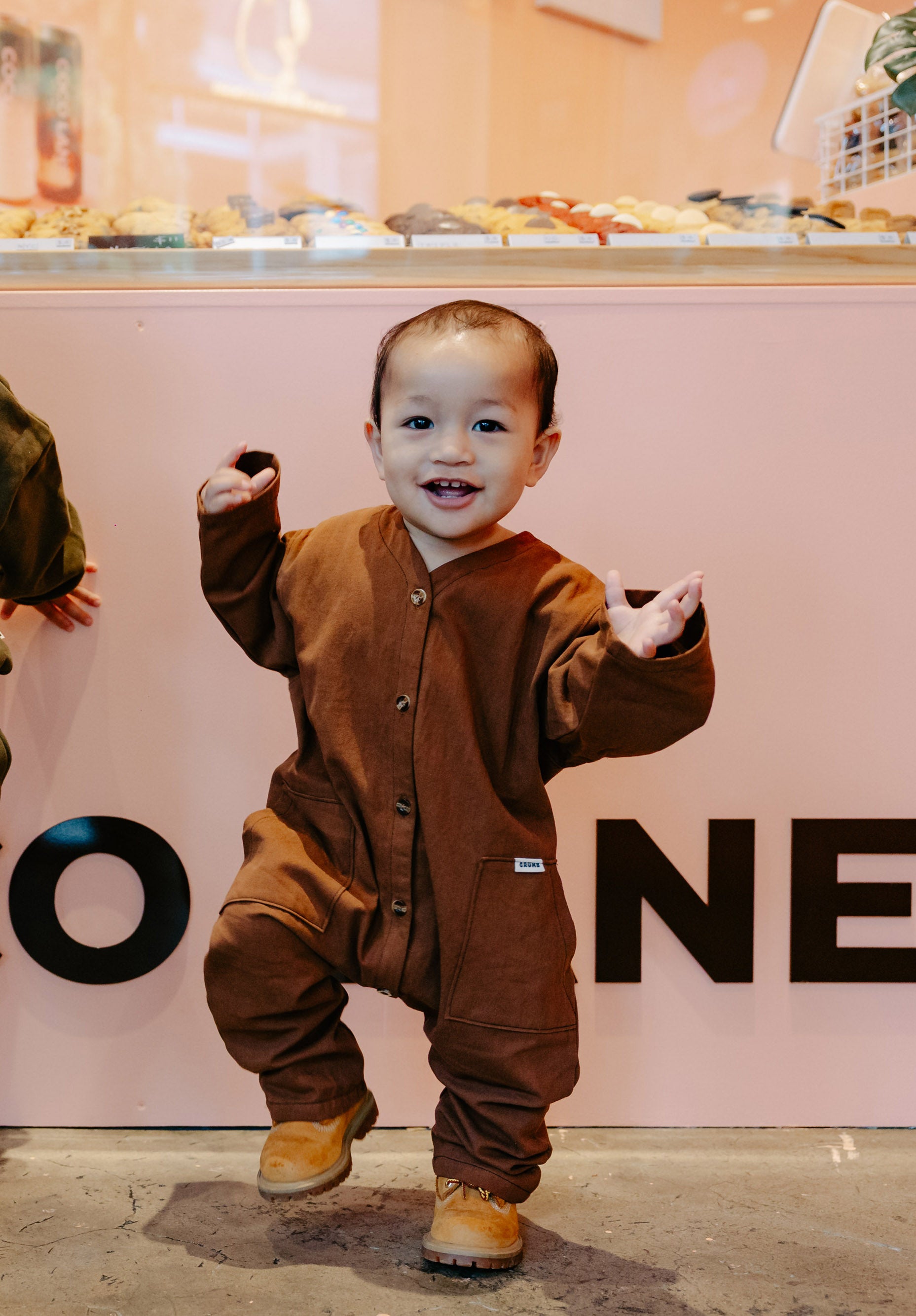 Child in Chocolate Brown Overalls from Crumb