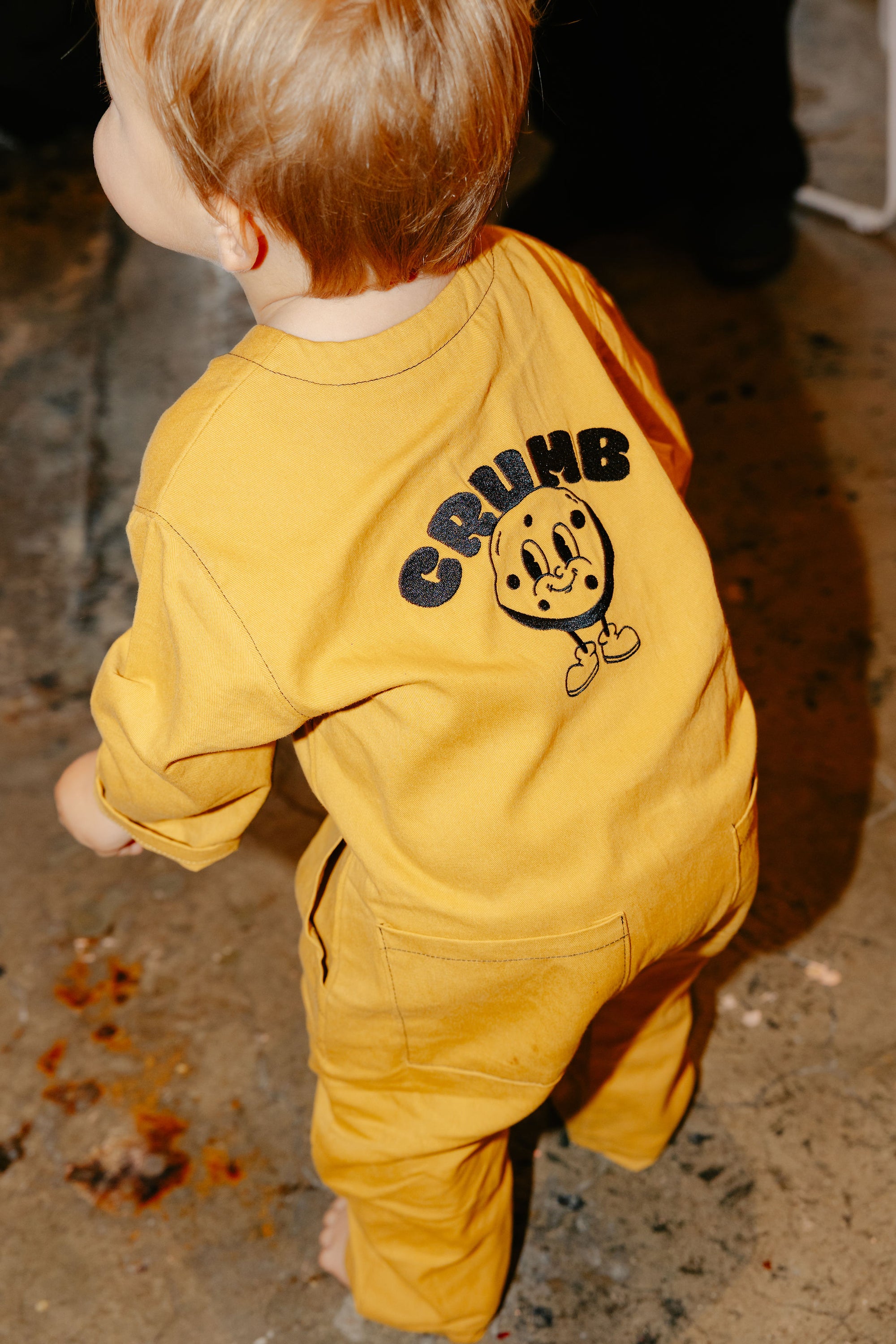 Child wearing our Crumb Honeycomb onesie