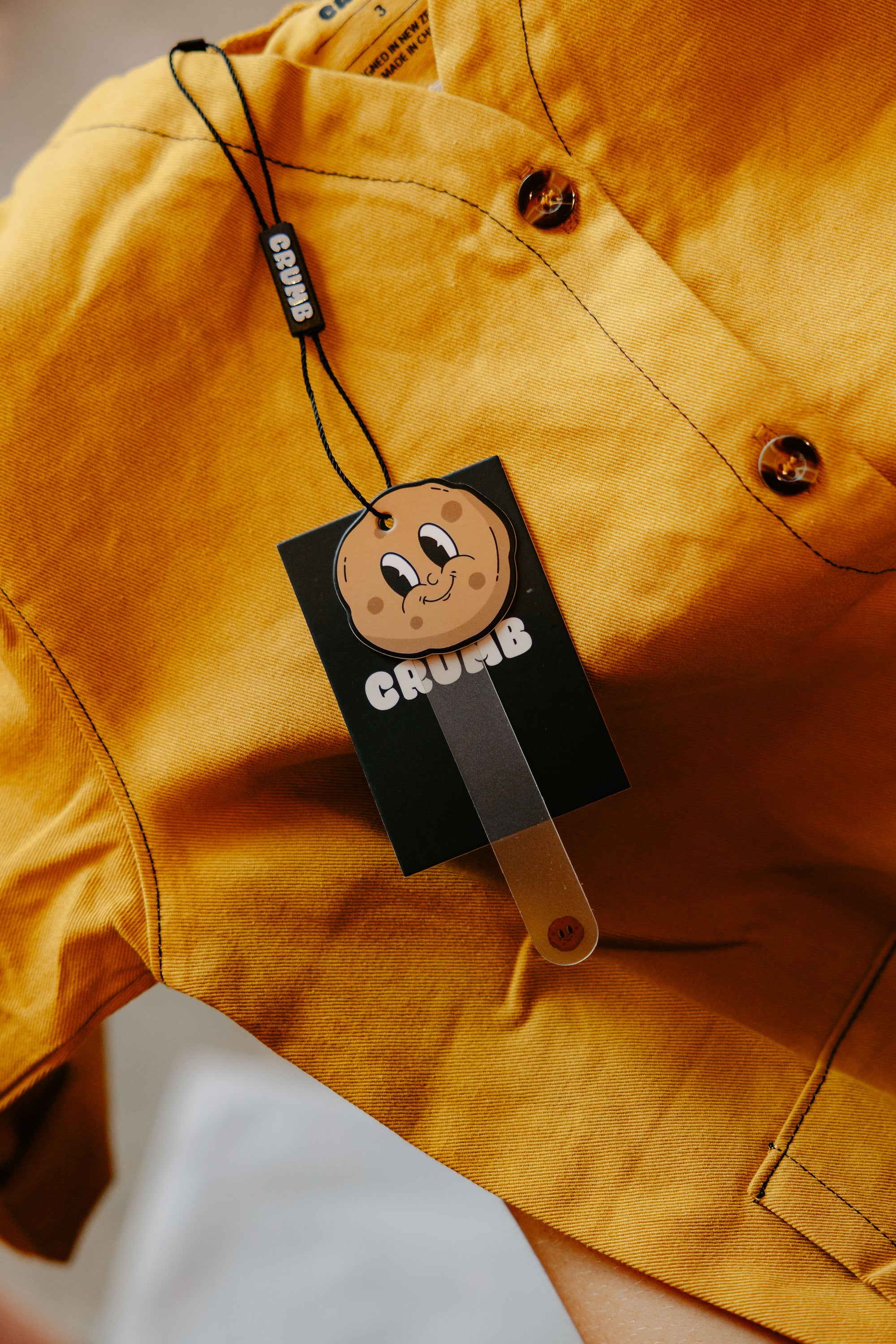 Front of the Crumb Honeycomb Off Beat Overalls with our cookie logo