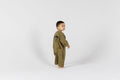 Child in green onesie from Crumb