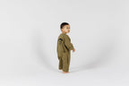 Child in green onesie from Crumb