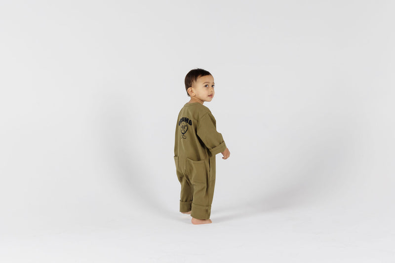Child in green onesie from Crumb