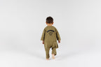 Child wearing kids overall in pistachio color by Crumb