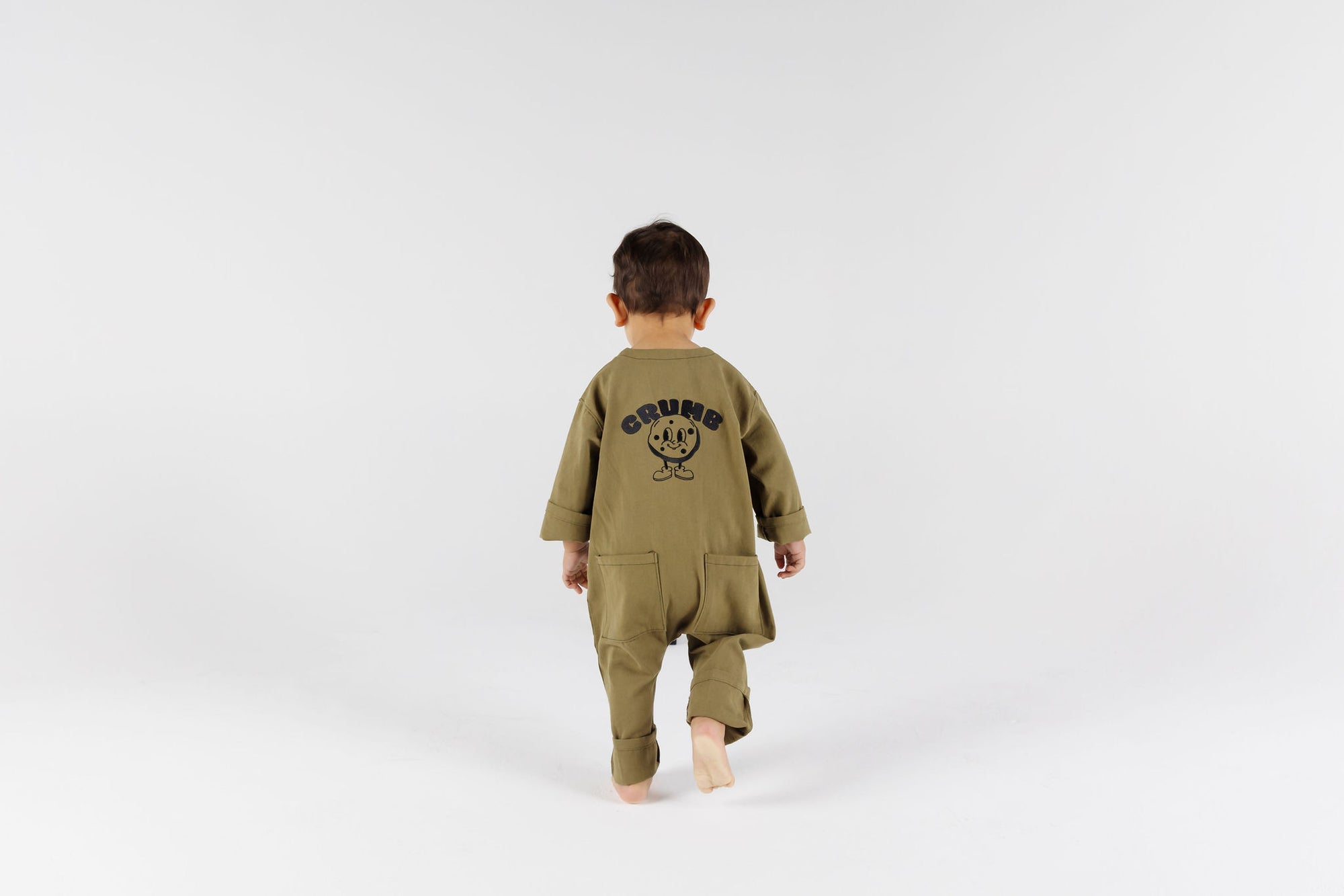 Child wearing kids overall in pistachio color by Crumb