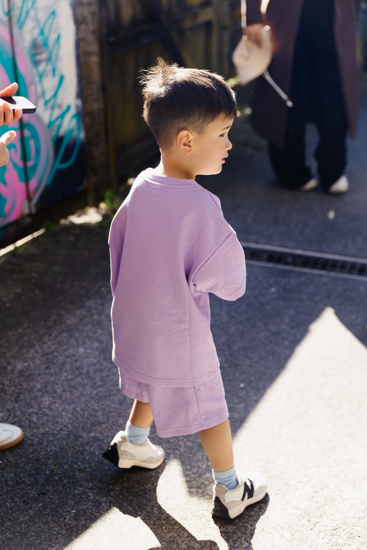 Kid outdoors in Crumb's Drop Sleeve Set Violet Crumble