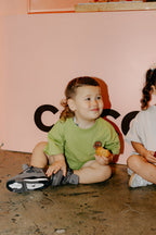 Kid with a cookie wearing Crumb's Drop Sleeve Set - Matcha Green