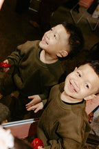 Happy kid wearing Downtown Set Pistachio Truffle kids tracksuit