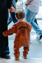 Child in Chocolate Brown Off Beat Overalls walking outdoors